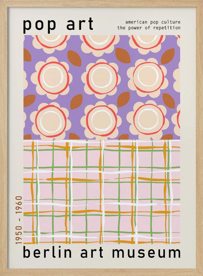 A framed pop art museum poster advertising an exhibition at the Berlin Art Museum. The poster features two distinct patterns. The top section has repeating stylized cream and red flowers on a purple background, with the words 'pop art' and 'american pop culture the power of repetition'. The bottom section displays a pink, green, and orange plaid pattern. The dates '1950 - 1960' are printed vertically on the side. Artwork