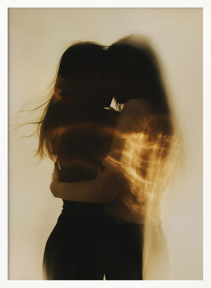 An artistic, long-exposure photograph of two silhouetted figures embracing. Their forms are blurred with motion, and streaks of warm, golden light wash over them against a soft, off-white background, creating a dreamy and intimate mood. Decor