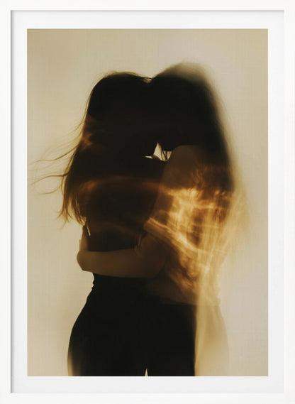 An artistic, long-exposure photograph of two silhouetted figures embracing. Their forms are blurred with motion, and streaks of warm, golden light wash over them against a soft, off-white background, creating a dreamy and intimate mood. Decor