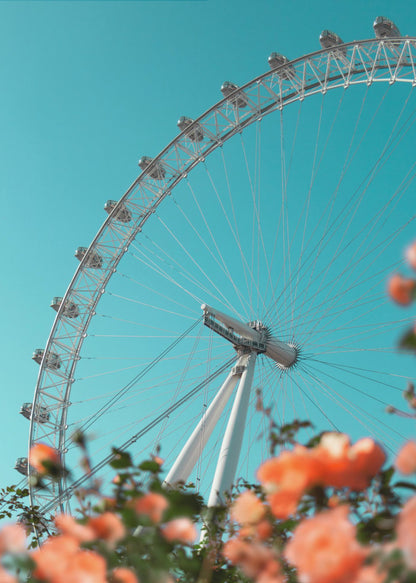 A low-angle shot of the London Eye ferris wheel against a clear, vibrant teal sky. In the foreground, out-of-focus orange flowers create a soft, colorful frame. Poster