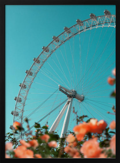 A low-angle shot of the London Eye ferris wheel against a clear, vibrant teal sky. In the foreground, out-of-focus orange flowers create a soft, colorful frame. Poster