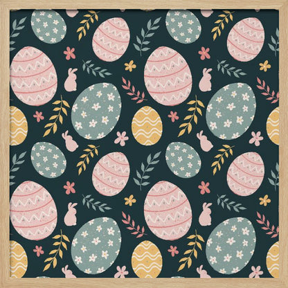 A framed piece of art with a repeating Easter pattern on a dark teal background. The pattern features decorated eggs in pink, light blue, and yellow, alongside small pink bunny silhouettes and colorful sprigs of leaves and flowers. Poster