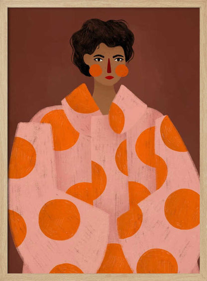 A stylized portrait illustration of a person with dark curly hair and warm brown skin against a solid reddish-brown background. They wear a light pink, oversized coat with large orange polka dots, and look directly forward with a neutral expression, accented by red lipstick and circular orange blush. Decor