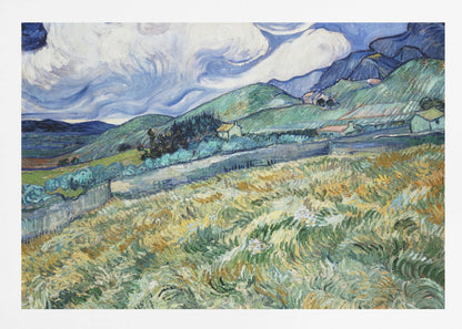 A framed Post-Impressionist painting by Vincent van Gogh depicting a vibrant, rolling landscape. The foreground is filled with swirling brushstrokes of green and yellow fields, leading back to green hills dotted with small houses. In the background, dark blue mountains rise up to meet a dramatic sky filled with large, swirling white clouds against a deep blue. Wall Art