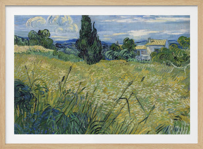 Vincent van Gogh's painting 'Green Wheat Field with Cypress' in a silver frame. The artwork features a vibrant golden-yellow field with green stalks in the foreground, a towering dark green cypress tree at the center, and a small farmhouse in the background under a blue sky with stylized, swirling white clouds. The entire scene is rendered in the artist's characteristic thick, expressive brushstrokes. Print