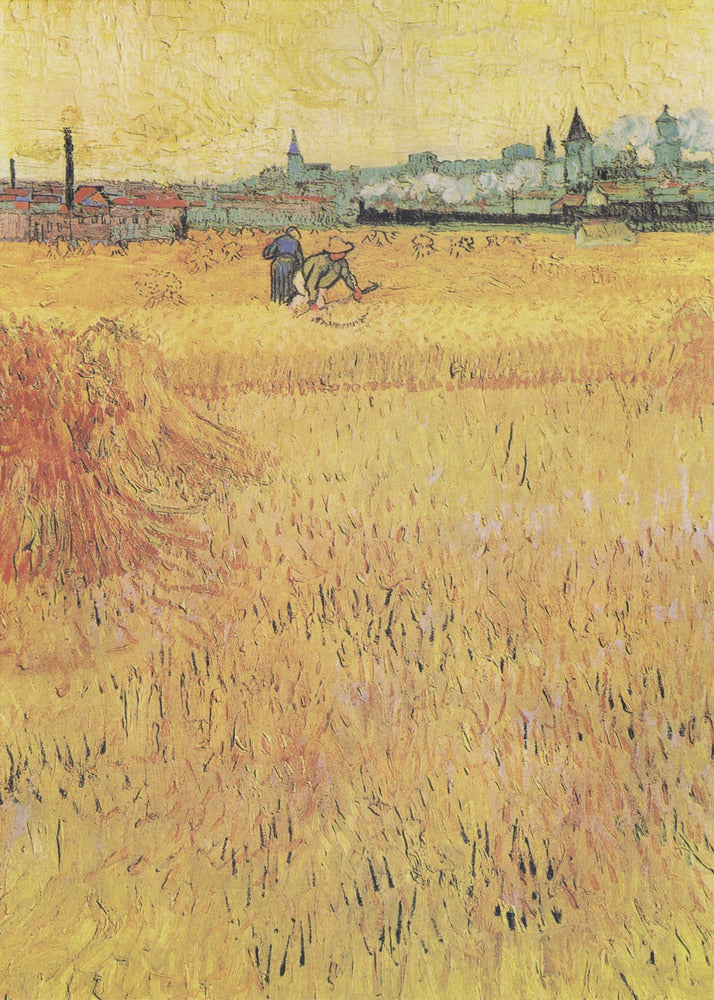 A Post-Impressionist painting by Vincent van Gogh depicting a vast, golden wheat field under a yellow sky. Two figures are harvesting wheat in the middle distance, with a town and industrial buildings on the horizon. The artwork is characterized by thick, textured brushstrokes and is displayed in a black frame. Print