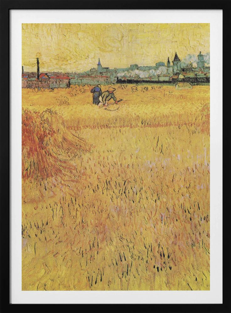 A Post-Impressionist painting by Vincent van Gogh depicting a vast, golden wheat field under a yellow sky. Two figures are harvesting wheat in the middle distance, with a town and industrial buildings on the horizon. The artwork is characterized by thick, textured brushstrokes and is displayed in a black frame. Print