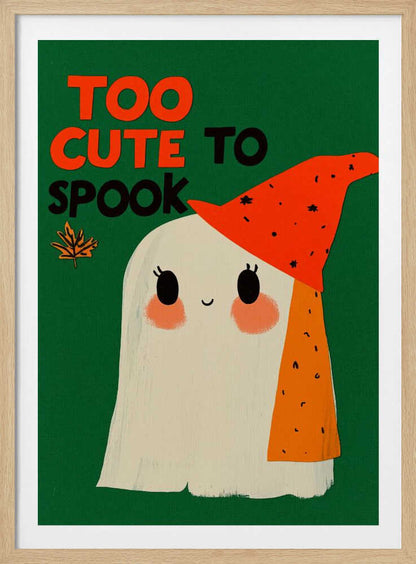 A whimsical illustration of a friendly white ghost with rosy cheeks and a smiling face, wearing a pointy orange hat with black flecks. The background is a solid dark green, and above the ghost, the text 'TOO CUTE TO SPOOK' is written in orange and black block letters, next to a small autumn leaf. Artwork