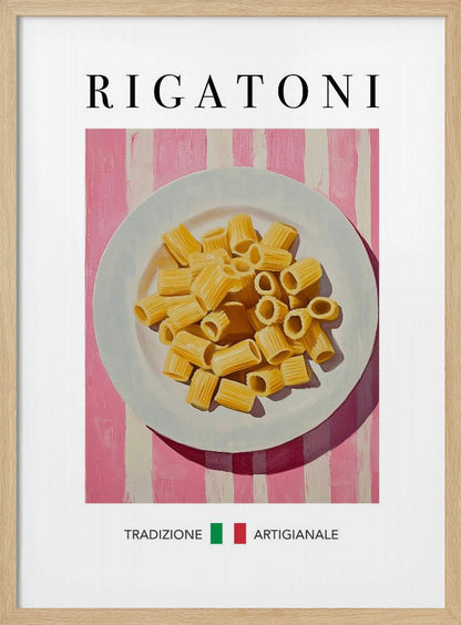 A framed art print of a vintage-style Italian food poster. It features a painting of a white plate full of uncooked rigatoni pasta on a pink and white striped background. The word 'RIGATONI' is printed in large black letters at the top, and 'TRADIZIONE ARTIGIANALE' with a small Italian flag is printed at the bottom. Artwork