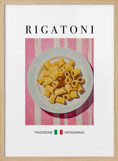 A framed art print of a vintage-style Italian food poster. It features a painting of a white plate full of uncooked rigatoni pasta on a pink and white striped background. The word 'RIGATONI' is printed in large black letters at the top, and 'TRADIZIONE ARTIGIANALE' with a small Italian flag is printed at the bottom. Artwork