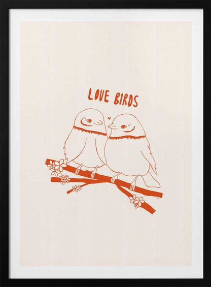 A framed art print featuring a minimalist, reddish-orange illustration on a cream background. Two cartoonish, plump birds sit close together on a flowering branch, looking at each other affectionately. Above them, the text 'LOVE BIRDS' is written in a playful, rounded font. Decor