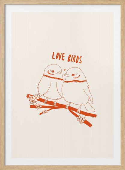 A framed art print featuring a minimalist, reddish-orange illustration on a cream background. Two cartoonish, plump birds sit close together on a flowering branch, looking at each other affectionately. Above them, the text 'LOVE BIRDS' is written in a playful, rounded font. Decor