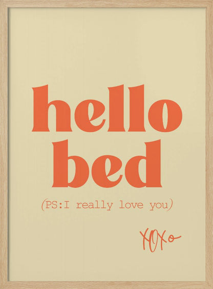 A framed art print with a cream-colored background. The words 'hello bed' are printed in a large, bold, orange serif font. Below this, in a smaller orange font, it reads '(PS: I really love you)'. In the bottom right corner, 'XOXO' is written in an orange script font. Decor