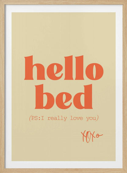 A framed art print with a cream-colored background. The words 'hello bed' are printed in a large, bold, orange serif font. Below this, in a smaller orange font, it reads '(PS: I really love you)'. In the bottom right corner, 'XOXO' is written in an orange script font. Decor