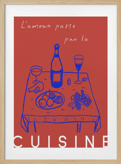 A vintage-style poster with a red background featuring a blue line drawing of a dinner table set with wine and fruit. Above the image is the French phrase 'L'amour passe par la' in white cursive script, and below is the word 'CUISINE' in a bold white font, completing the saying 'Love passes through the kitchen'. Wall Art