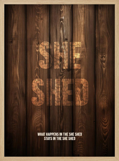 A rustic poster with a dark brown wood panel background. The words 'SHE SHED' are in large, blocky letters with a distressed wood texture. Below, a smaller caption reads 'WHAT HAPPENS IN THE SHE SHED STAYS IN THE SHE SHED'. The poster is displayed in a thin black frame. Print