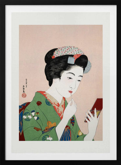 A Japanese ukiyo-e woodblock print of a woman in a green kimono applying red lipstick while looking into a small handheld mirror. Her black hair is elaborately styled, and the background is a soft pink. Artwork