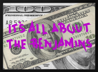 A pop art piece featuring a close-up of a one-hundred-dollar bill. The phrase 'IT'S ALL ABOUT THE BENJAMINS' is written across the image in a messy, graffiti-style font in a vibrant magenta color. The artwork is set within a silver frame. Wall Art
