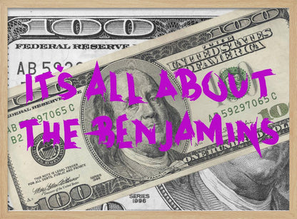 A pop art piece featuring a close-up of a one-hundred-dollar bill. The phrase 'IT'S ALL ABOUT THE BENJAMINS' is written across the image in a messy, graffiti-style font in a vibrant magenta color. The artwork is set within a silver frame. Wall Art