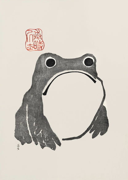 A minimalist Japanese-style ink wash painting of a stylized frog with a grumpy expression. The frog is rendered in black ink on a cream-colored paper, with a large white throat pouch. A red artist's seal is stamped above the frog's head. The artwork is presented in a simple black frame. Artwork