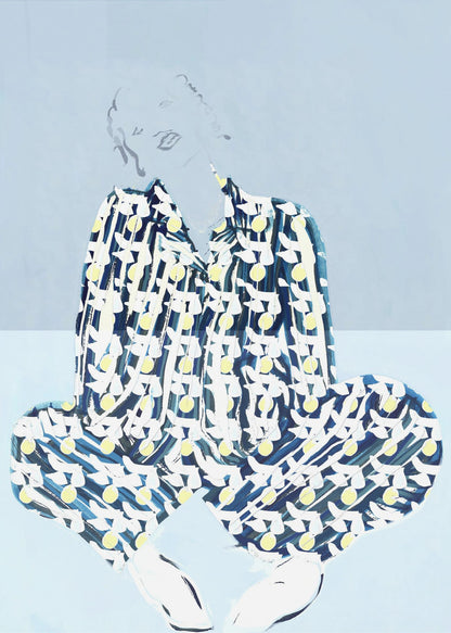 A framed fashion illustration of a person sitting cross-legged against a light blue background. The figure wears a bold, patterned blue, white, and yellow outfit, while their face and hair are rendered as faint, delicate line drawings. Wall Art