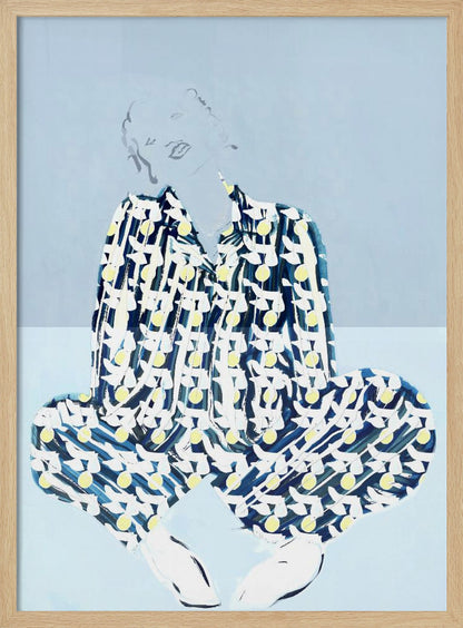 A framed fashion illustration of a person sitting cross-legged against a light blue background. The figure wears a bold, patterned blue, white, and yellow outfit, while their face and hair are rendered as faint, delicate line drawings. Wall Art