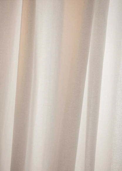 Abstract photo of light beige fabric with soft, flowing folds creating gentle shadows.