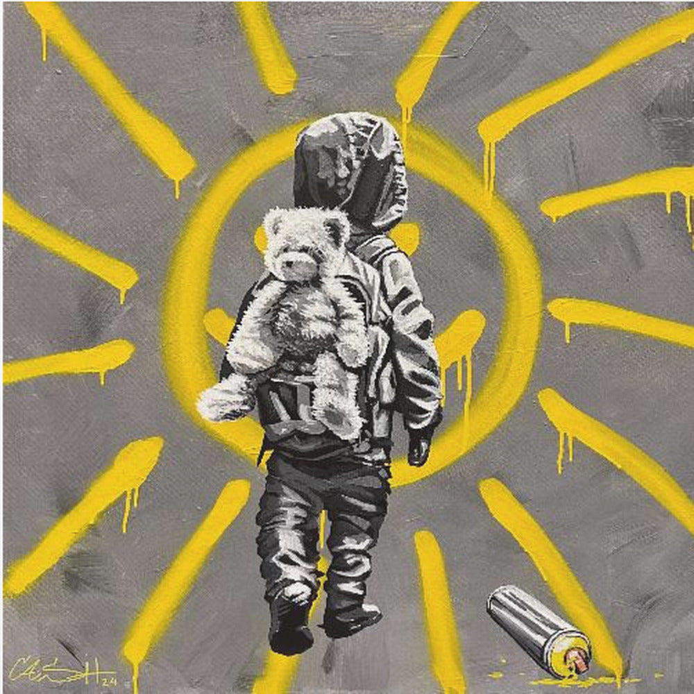 A framed street art-style painting with a grey background. A large, yellow, spray-painted sun with dripping rays dominates the scene. In the foreground, a small child in a dark hoodie and pants is depicted from behind in black and white, carrying a fluffy teddy bear on their back. A discarded spray paint can lies on the ground in the bottom right corner. Poster