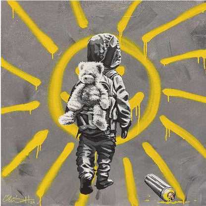 A framed street art-style painting with a grey background. A large, yellow, spray-painted sun with dripping rays dominates the scene. In the foreground, a small child in a dark hoodie and pants is depicted from behind in black and white, carrying a fluffy teddy bear on their back. A discarded spray paint can lies on the ground in the bottom right corner. Poster