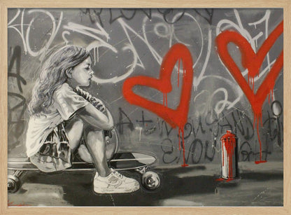 A monochrome street art painting of a young girl with long hair sitting thoughtfully on a skateboard. Behind her, a grey wall is covered in graffiti tags and two large, bright red hearts are spray-painted with drips running down. A red and white spray paint can sits on the ground next to her. Artwork