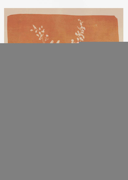A botanical block print style illustration of a plant with large, pointed leaves and delicate flowering sprigs. The plant is rendered in a creamy off-white against a textured, burnt orange background. The artwork is presented in a simple black frame. Print