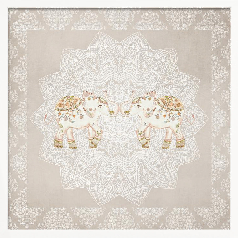 A framed artwork depicting two small, ornate elephants facing each other in the center, their trunks touching. They are decorated with colorful floral patterns and stand against a large, intricate white mandala on a light beige background. The piece is bordered with a white pattern and set in a light wood frame. Wall Art