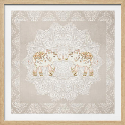 A framed artwork depicting two small, ornate elephants facing each other in the center, their trunks touching. They are decorated with colorful floral patterns and stand against a large, intricate white mandala on a light beige background. The piece is bordered with a white pattern and set in a light wood frame. Wall Art