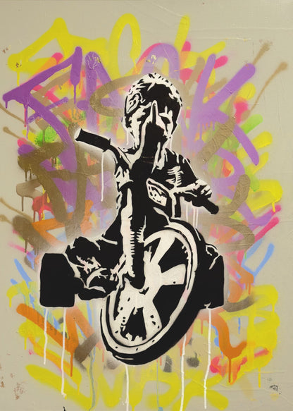 A framed street art piece featuring a black and white stencil of a rebellious child on a tricycle giving the middle finger, set against a vibrant, multi-colored graffiti background with paint drips. Artwork