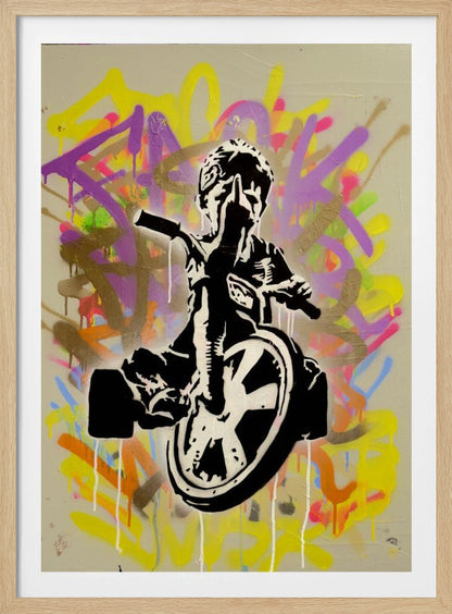 A framed street art piece featuring a black and white stencil of a rebellious child on a tricycle giving the middle finger, set against a vibrant, multi-colored graffiti background with paint drips. Artwork