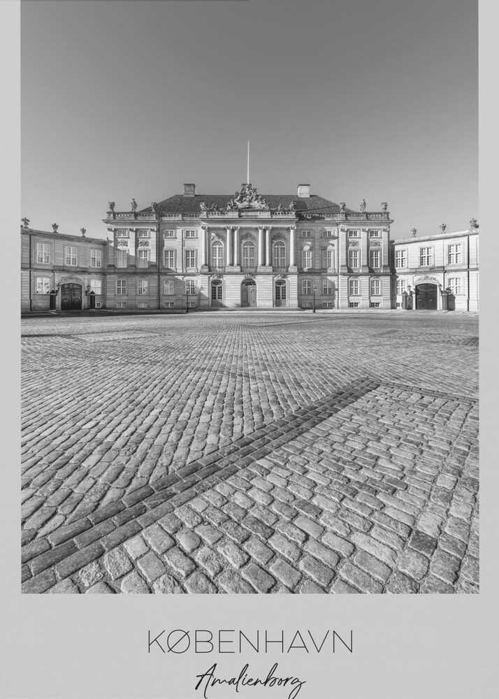 A framed, vertical black and white photograph of Amalienborg Palace in Copenhagen. The shot is taken from a low angle, emphasizing the large cobblestone square in the foreground. The palace stands symmetrically in the background under a clear sky. At the bottom of the poster, text reads 'KØBENHAVN', 'Amalienborg', and 'DANMARK'. Poster