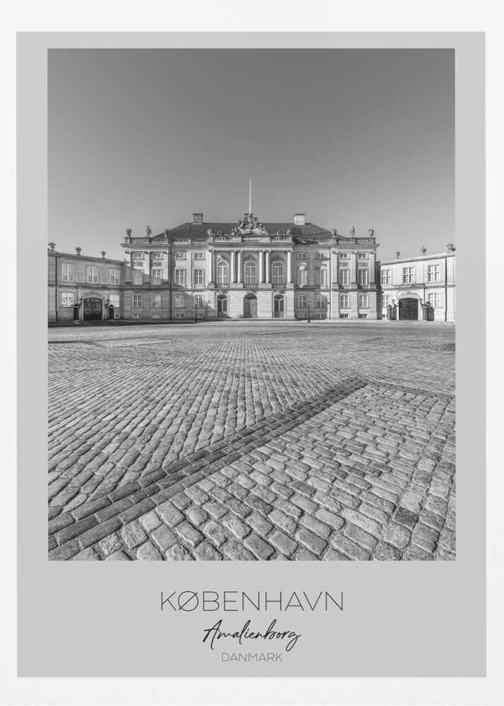 A framed, vertical black and white photograph of Amalienborg Palace in Copenhagen. The shot is taken from a low angle, emphasizing the large cobblestone square in the foreground. The palace stands symmetrically in the background under a clear sky. At the bottom of the poster, text reads 'KØBENHAVN', 'Amalienborg', and 'DANMARK'. Poster