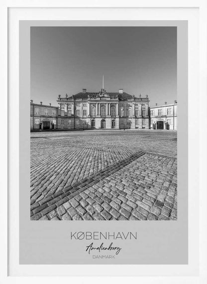 A framed, vertical black and white photograph of Amalienborg Palace in Copenhagen. The shot is taken from a low angle, emphasizing the large cobblestone square in the foreground. The palace stands symmetrically in the background under a clear sky. At the bottom of the poster, text reads 'KØBENHAVN', 'Amalienborg', and 'DANMARK'. Poster
