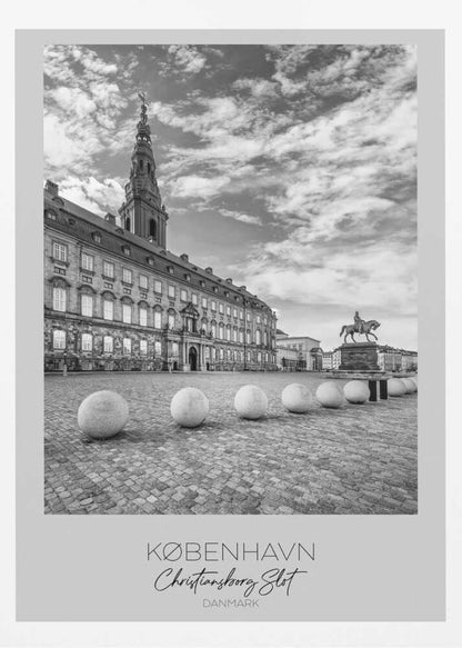 A black and white travel poster of Christiansborg Palace in Copenhagen, Denmark. The image shows the grand building and its tower against a dramatic cloudy sky, with a cobblestone square, stone bollards, and an equestrian statue in the foreground. Text at the bottom identifies the location. Decor