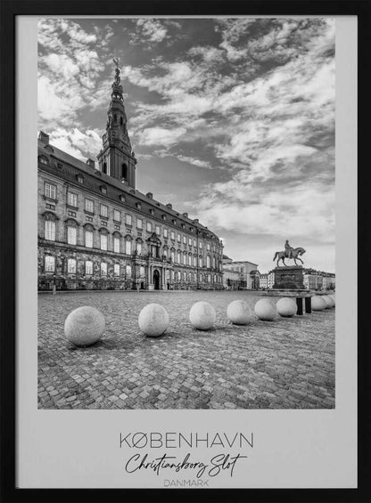 A black and white travel poster of Christiansborg Palace in Copenhagen, Denmark. The image shows the grand building and its tower against a dramatic cloudy sky, with a cobblestone square, stone bollards, and an equestrian statue in the foreground. Text at the bottom identifies the location. Decor