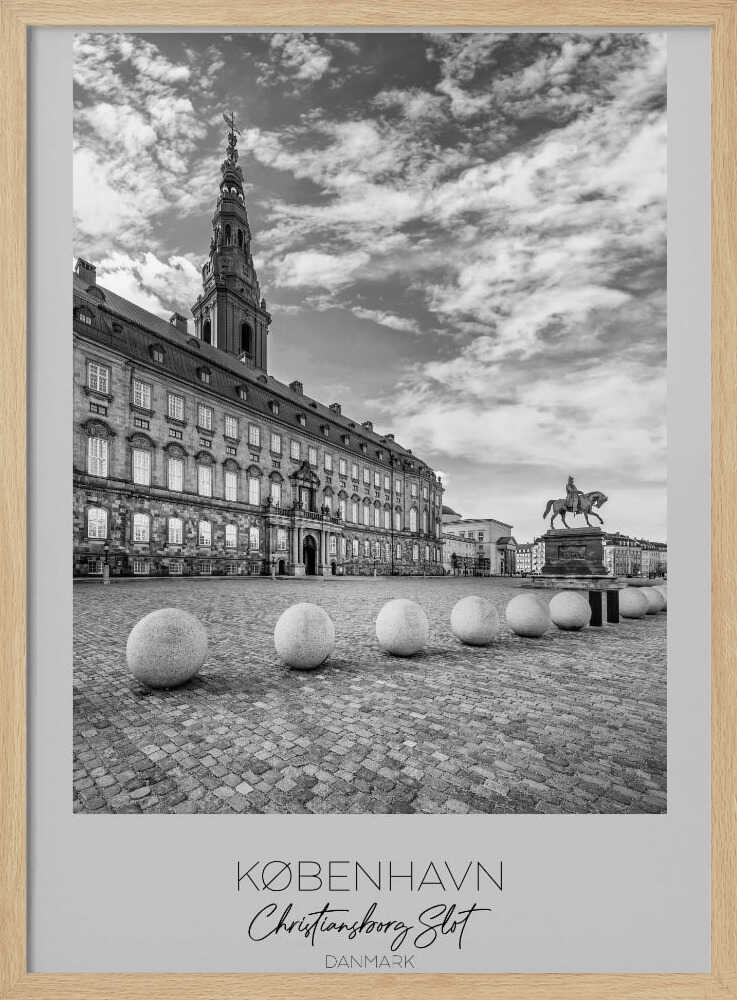 A black and white travel poster of Christiansborg Palace in Copenhagen, Denmark. The image shows the grand building and its tower against a dramatic cloudy sky, with a cobblestone square, stone bollards, and an equestrian statue in the foreground. Text at the bottom identifies the location. Decor