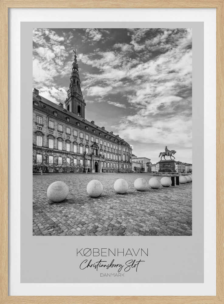 A black and white travel poster of Christiansborg Palace in Copenhagen, Denmark. The image shows the grand building and its tower against a dramatic cloudy sky, with a cobblestone square, stone bollards, and an equestrian statue in the foreground. Text at the bottom identifies the location. Decor
