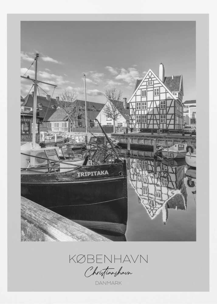 A black and white travel poster featuring a photo of Christianshavn in Copenhagen. The scene shows a boat named 'TRIPITAKA' docked in a canal, with a prominent half-timbered building across the water, its reflection visible on the surface. The bottom of the poster has text that reads 'KØBENHAVN', 'Christianshavn', and 'DANMARK'. Artwork