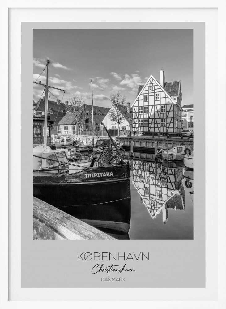 A black and white travel poster featuring a photo of Christianshavn in Copenhagen. The scene shows a boat named 'TRIPITAKA' docked in a canal, with a prominent half-timbered building across the water, its reflection visible on the surface. The bottom of the poster has text that reads 'KØBENHAVN', 'Christianshavn', and 'DANMARK'. Artwork
