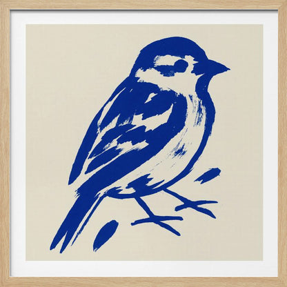 A stylized art print of a small bird, possibly a sparrow, rendered in bold cobalt blue ink with expressive brushstrokes. The bird is set against a solid cream background and enclosed in a light wood frame. Print