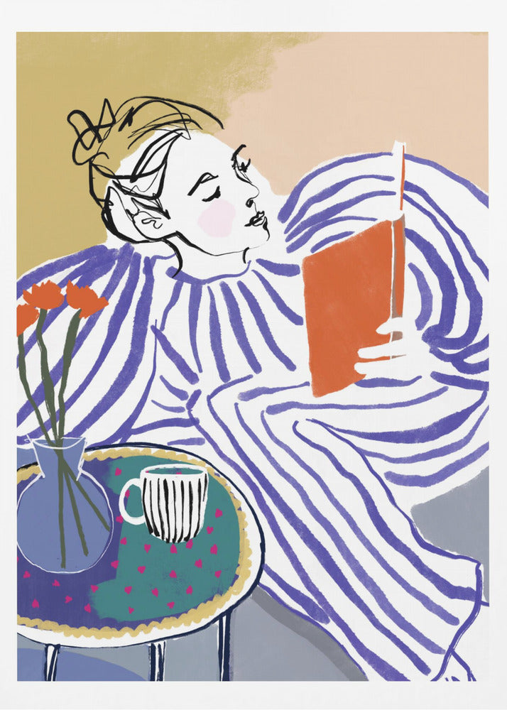 A stylized, framed illustration of a person with dark hair in a messy bun, wearing a blue and white striped top, reclining comfortably while engrossed in an orange book. Beside them is a small table with a blue vase holding three orange flowers and a black and white striped mug. The background is a soft beige color. Print