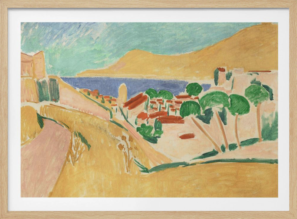 A Fauvist-style painting of a sunny coastal town, enclosed in a silver frame. The scene features warm yellow and pink hills, a village with red-roofed buildings and vibrant green trees, set against a deep blue sea and a large golden hill under a light blue sky. Print