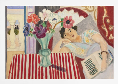 A Fauvist-style painting by Henri Matisse depicting a woman in a colorful blouse reclining with a book. Beside her is a table with a bold red-and-white striped cloth holding a light green vase with red, purple, and white anemone flowers. Print