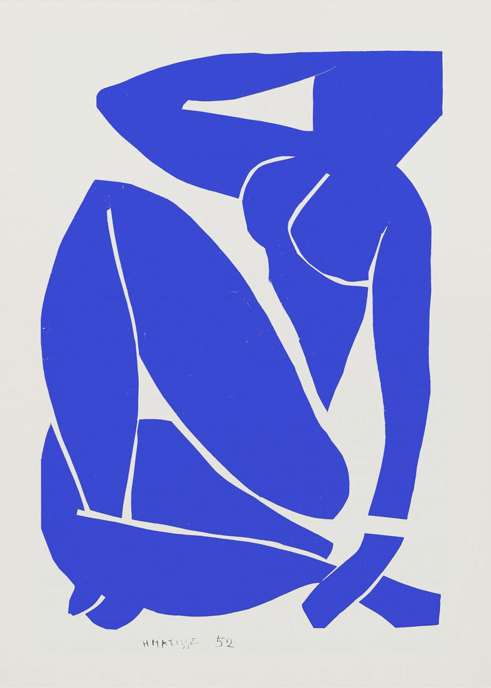 A framed print of Henri Matisse's 'Blue Nude II', featuring a bold, royal blue paper cutout of a seated female nude against an off-white background. The figure is stylized and abstract, with limbs folded and one arm behind her head. Print
