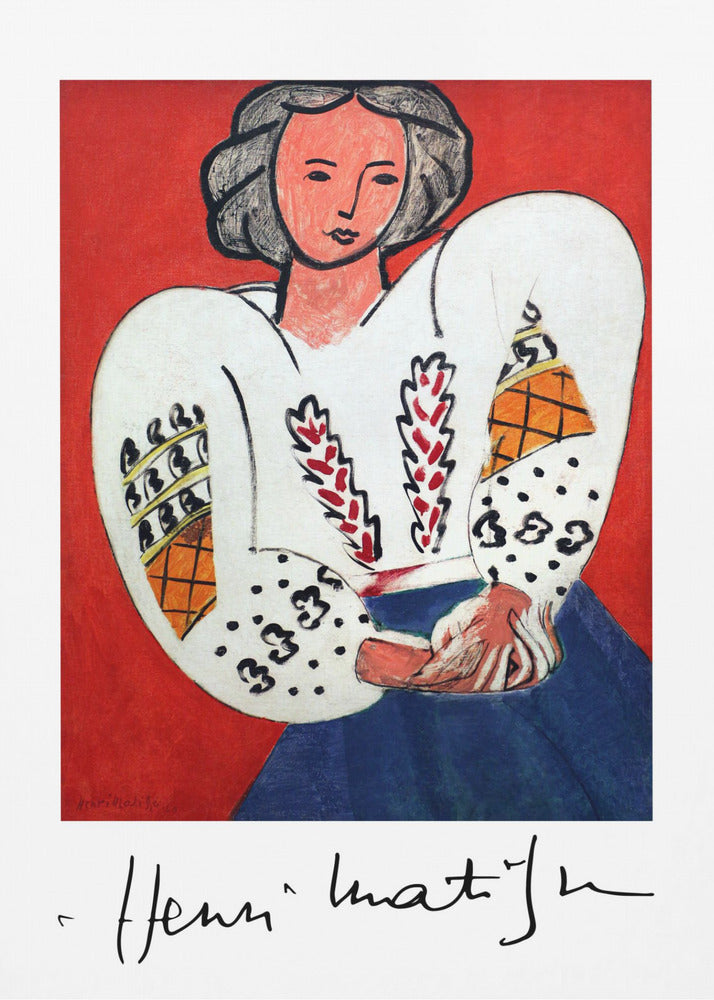 A framed art print of Henri Matisse's 'La Blouse Roumaine' (The Romanian Blouse). The painting depicts a woman with dark, styled hair against a vibrant solid red background. She is wearing a voluminous white blouse with puffy, intricately decorated sleeves and a dark blue skirt. Her hands are clasped in front of her. Below the image is the signature 'Henri Matisse'. Wall Art